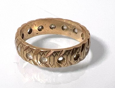 Lot 438 - A 9ct gold patterned eternity ring set with...