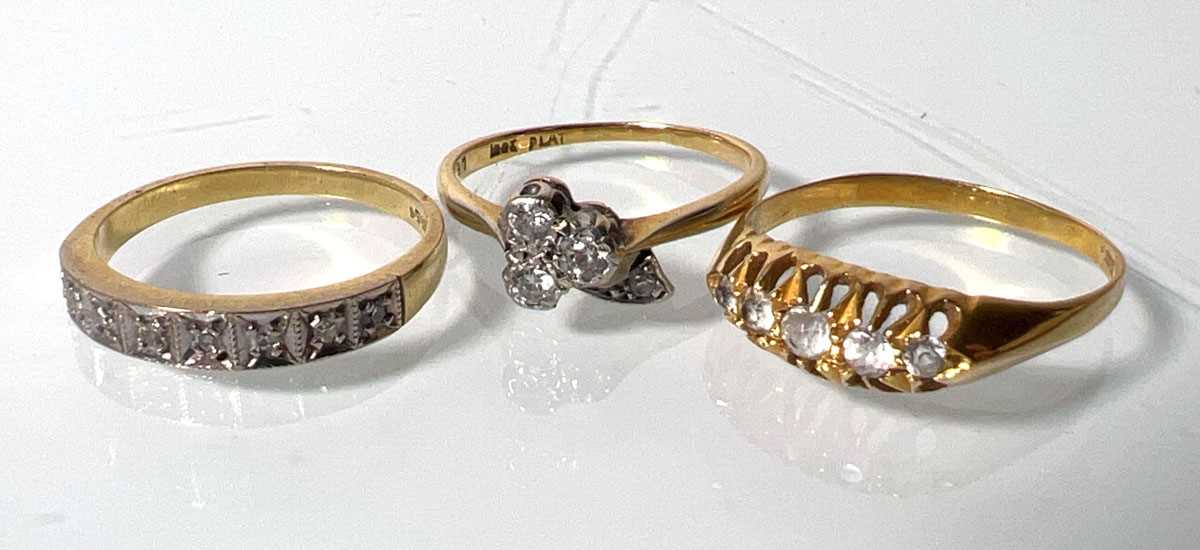 Lot 439 - An 18ct gold channel set diamond ring together...