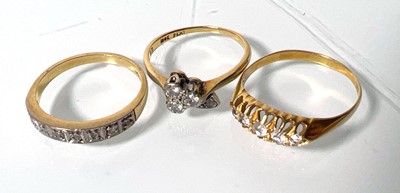 Lot 439 - An 18ct gold channel set diamond ring together...