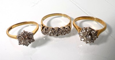 Lot 440 - An 18ct gold and diamond cluster ring together...