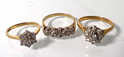Lot 440 - An 18ct gold and diamond cluster ring together...