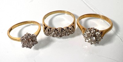 Lot 440 - An 18ct gold and diamond cluster ring together...