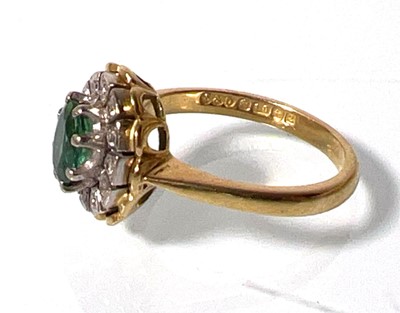 Lot 442 - An 18ct gold, emerald and diamond cluster ring....