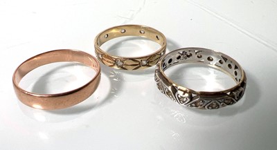 Lot 448 - Three yellow/white metal rings, one marked...