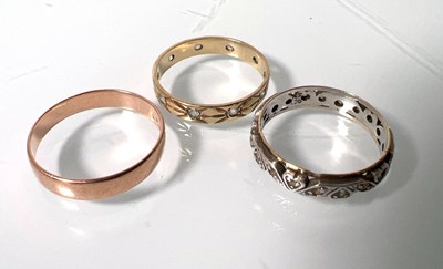 Lot 448 - Three yellow/white metal rings, one marked...