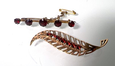 Lot 457 - A yellow metal and garnet leaf brooch marked...