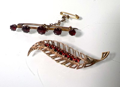 Lot 457 - A yellow metal and garnet leaf brooch marked...