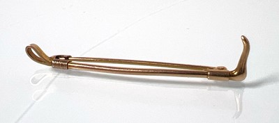 Lot 462 - A mid-20th century 9ct gold riding crop brooch....