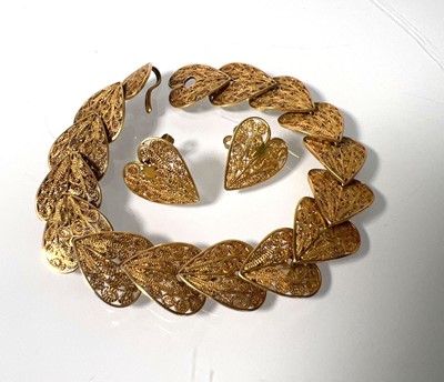 Lot 468 - A yellow metal filigree bracelet with heart...