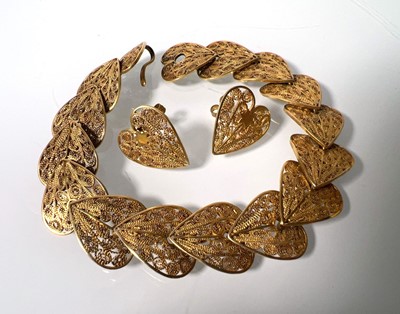 Lot 468 - A yellow metal filigree bracelet with heart...