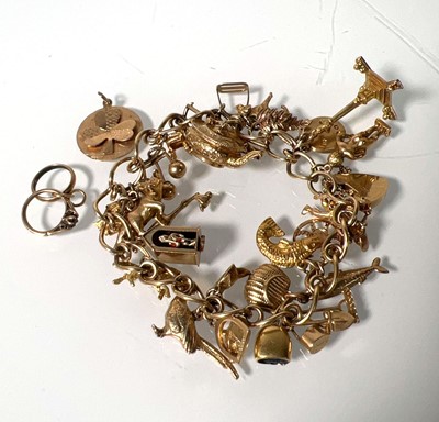 Lot 469 - A 9ct gold charm bracelet suspending an...