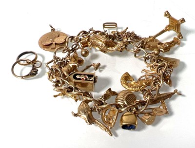 Lot 469 - A 9ct gold charm bracelet suspending an...