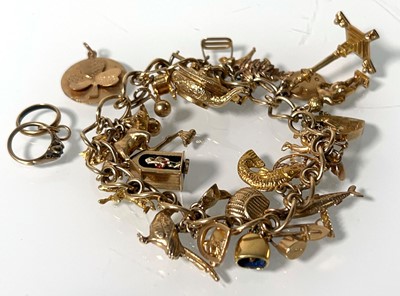 Lot 469 - A 9ct gold charm bracelet suspending an...