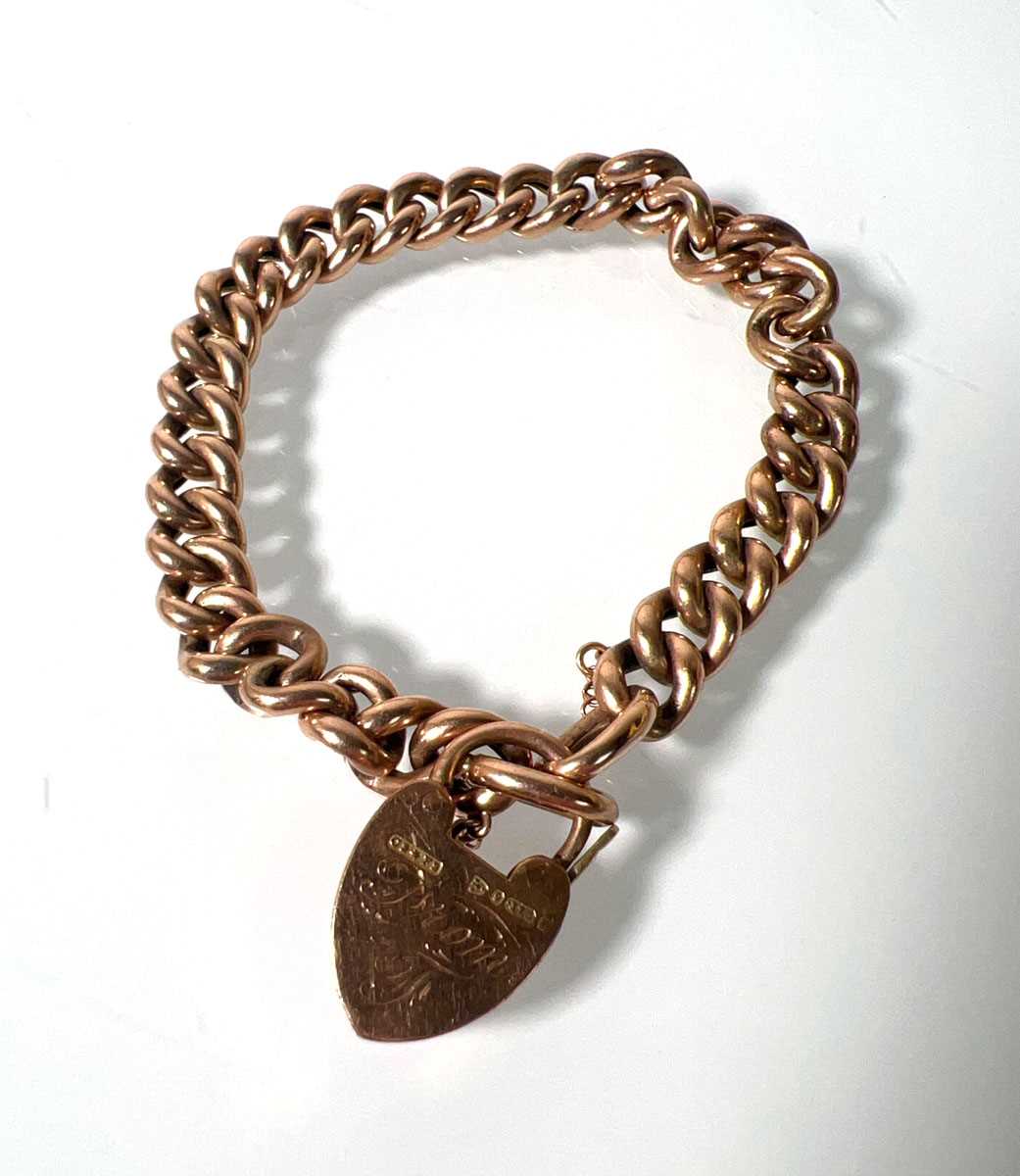 Lot 470 - A 9ct rose gold curb bracelet with heart...