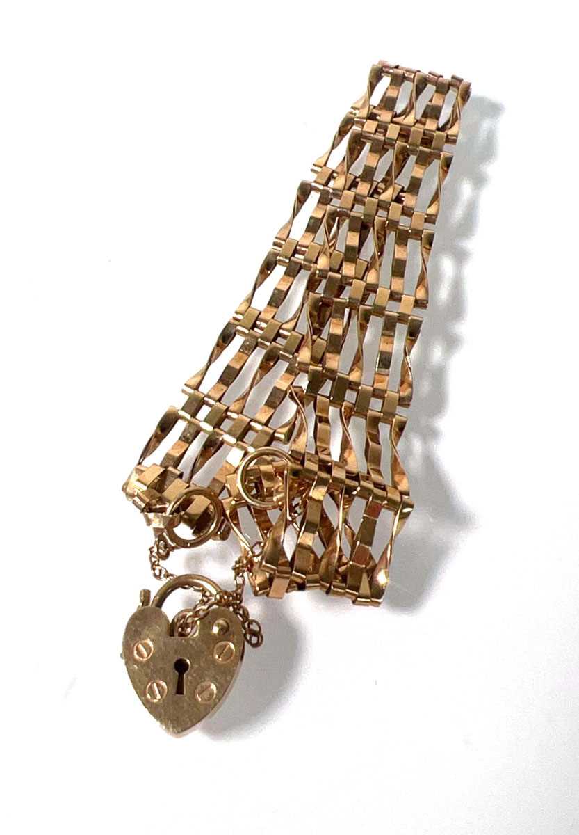 Lot 479 - A 9ct gold five-bar gate bracelet. Approx....