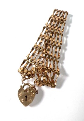 Lot 479 - A 9ct gold five-bar gate bracelet. Approx....