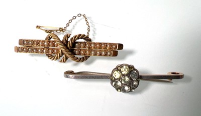 Lot 436 - A yellow metal and seed pearl knot brooch...