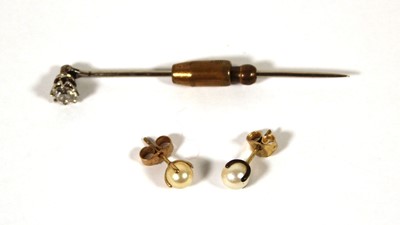 Lot 493 - A white metal and diamond stick pin, the round...
