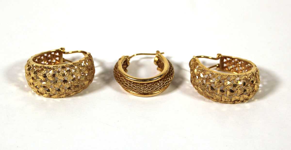 Lot 501 - A pair of yellow metal hoop earrings marked...