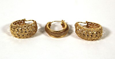 Lot 501 - A pair of yellow metal hoop earrings marked...