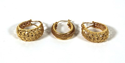 Lot 501 - A pair of yellow metal hoop earrings marked...
