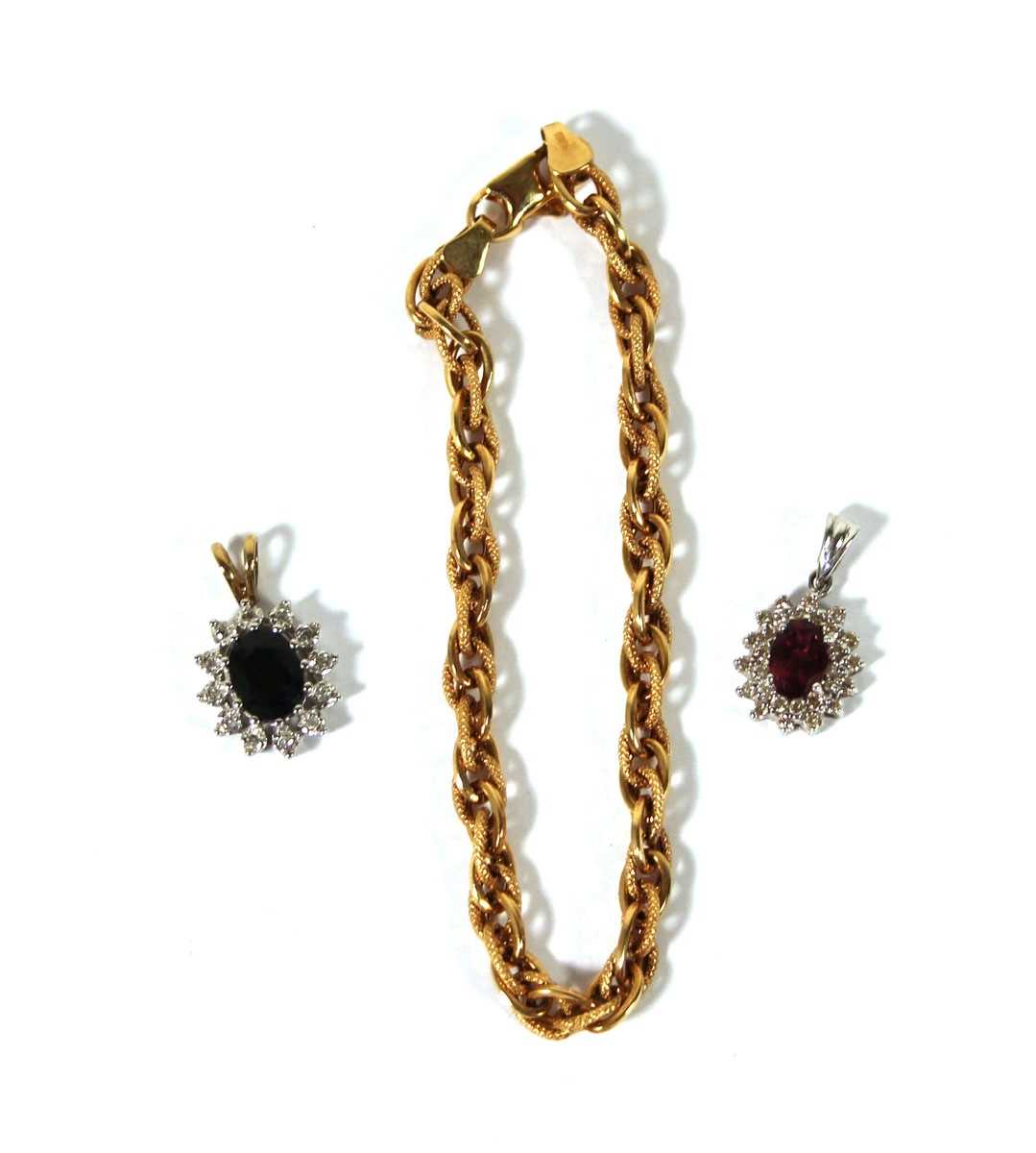 Lot 504 - A 9ct white gold, ruby and diamond cluster...