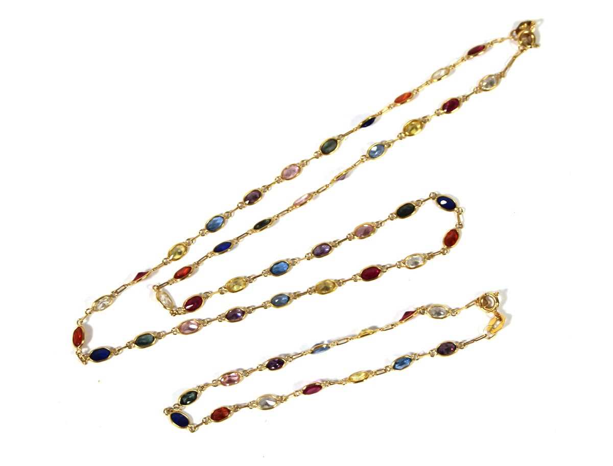 Lot 505 - A yellow metal multi-gem necklace marked '750'...