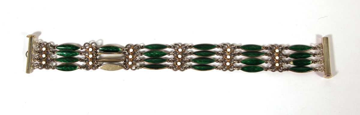 Lot 513 - A white metal and enamel four-bar bracelet in...