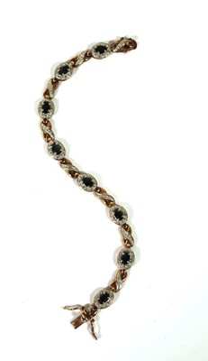 Lot 517 - A yellow metal and sapphire bracelet marked...