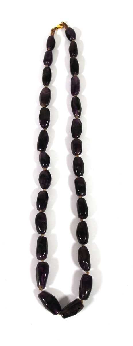 Lot 518 - An amethyst necklace with yellow metal clasp...