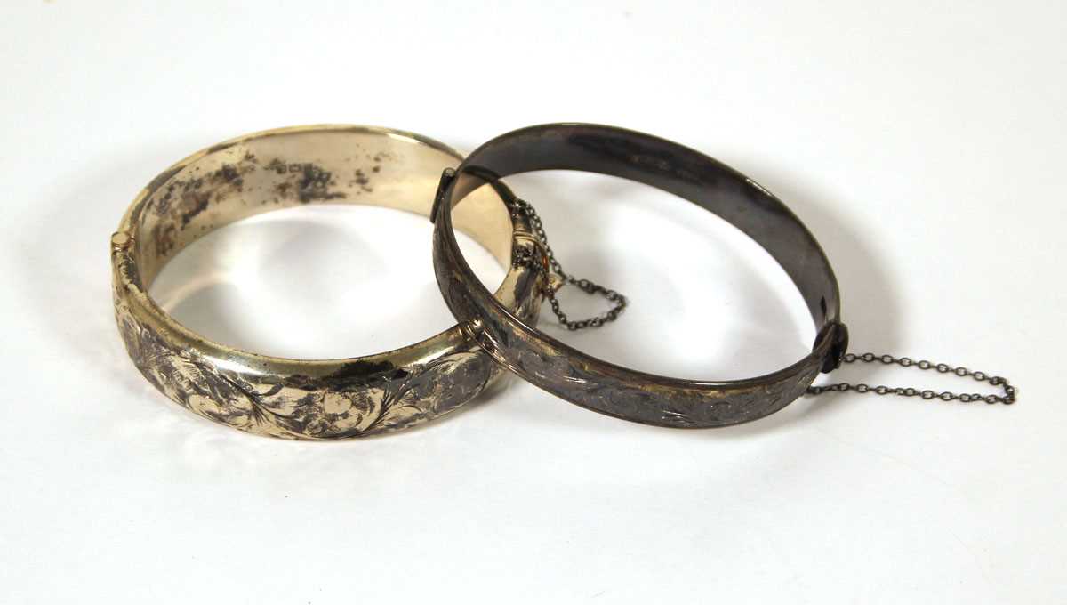 Lot 519 - Two silver engraved bangles, approx. weight 50g