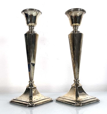 Lot 367 - A pair of silver candlesticks of tapered form,...