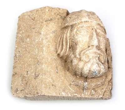 Lot 105 - A carved stone plaque relief modelled as a...