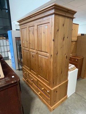 Lot 1343 - Large pine triple wardrobe on base with 3 over...