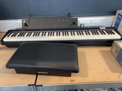 Lot 1731 - Roland FP-10 digital piano with a stool, music...