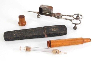 Lot 110 - A boxwood case containing a glass syringe...