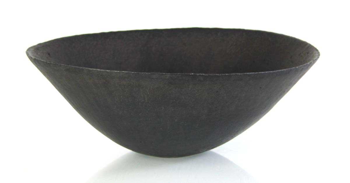 Lot John Ward (1938-2023), a black glazed...
