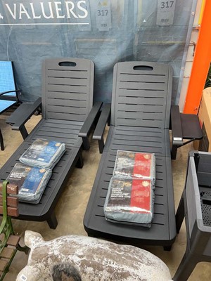 Lot 2343 - Pair of black plastic garden sun loungers