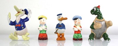Lot 169 - Disneyana: Two toothbrush holders modelled as...