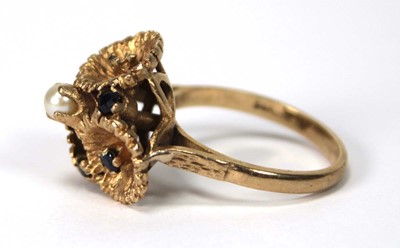Lot 514 - A 9ct yellow gold ring set small sapphires and...