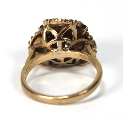 Lot 514 - A 9ct yellow gold ring set small sapphires and...