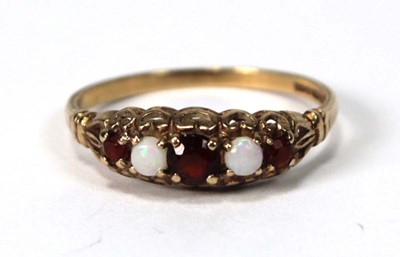 Lot 516 - A 9ct yellow gold ring set garnet and opal,...
