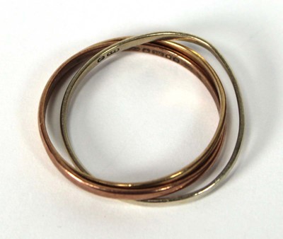 Lot 519 - A 9ct tri-colour triple puzzle type band ring,...