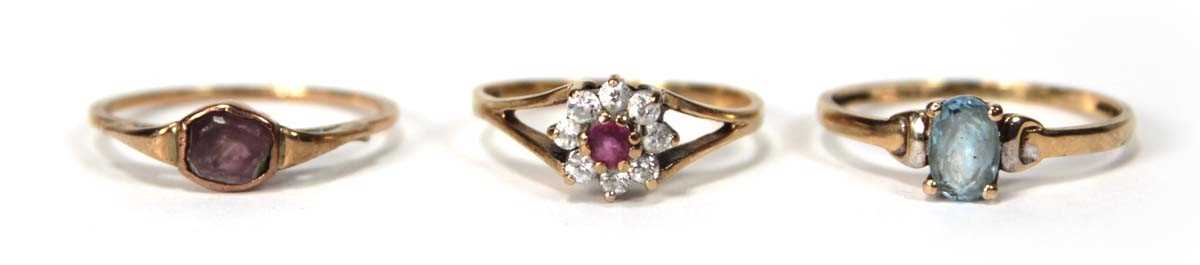 Lot 525 - A 9ct yellow gold cluster ring set ruby and...