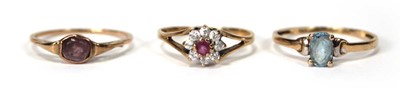 Lot 525 - A 9ct yellow gold cluster ring set ruby and...