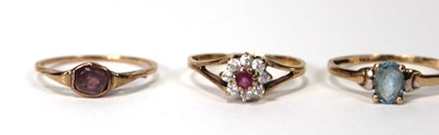 Lot 525 - A 9ct yellow gold cluster ring set ruby and...