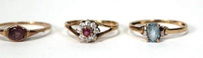 Lot 525 - A 9ct yellow gold cluster ring set ruby and...