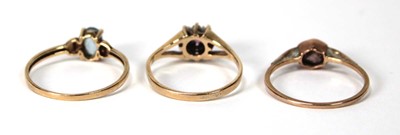 Lot 525 - A 9ct yellow gold cluster ring set ruby and...