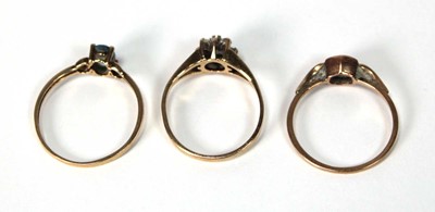 Lot 525 - A 9ct yellow gold cluster ring set ruby and...