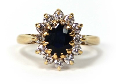 Lot 530 - An 18ct yellow gold cluster ring set oval...